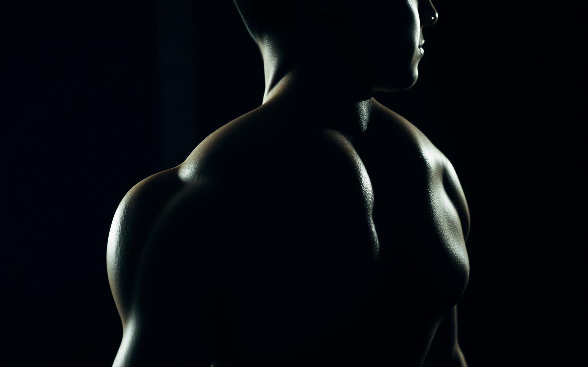 Athlete's sculpted back in dramatic side light